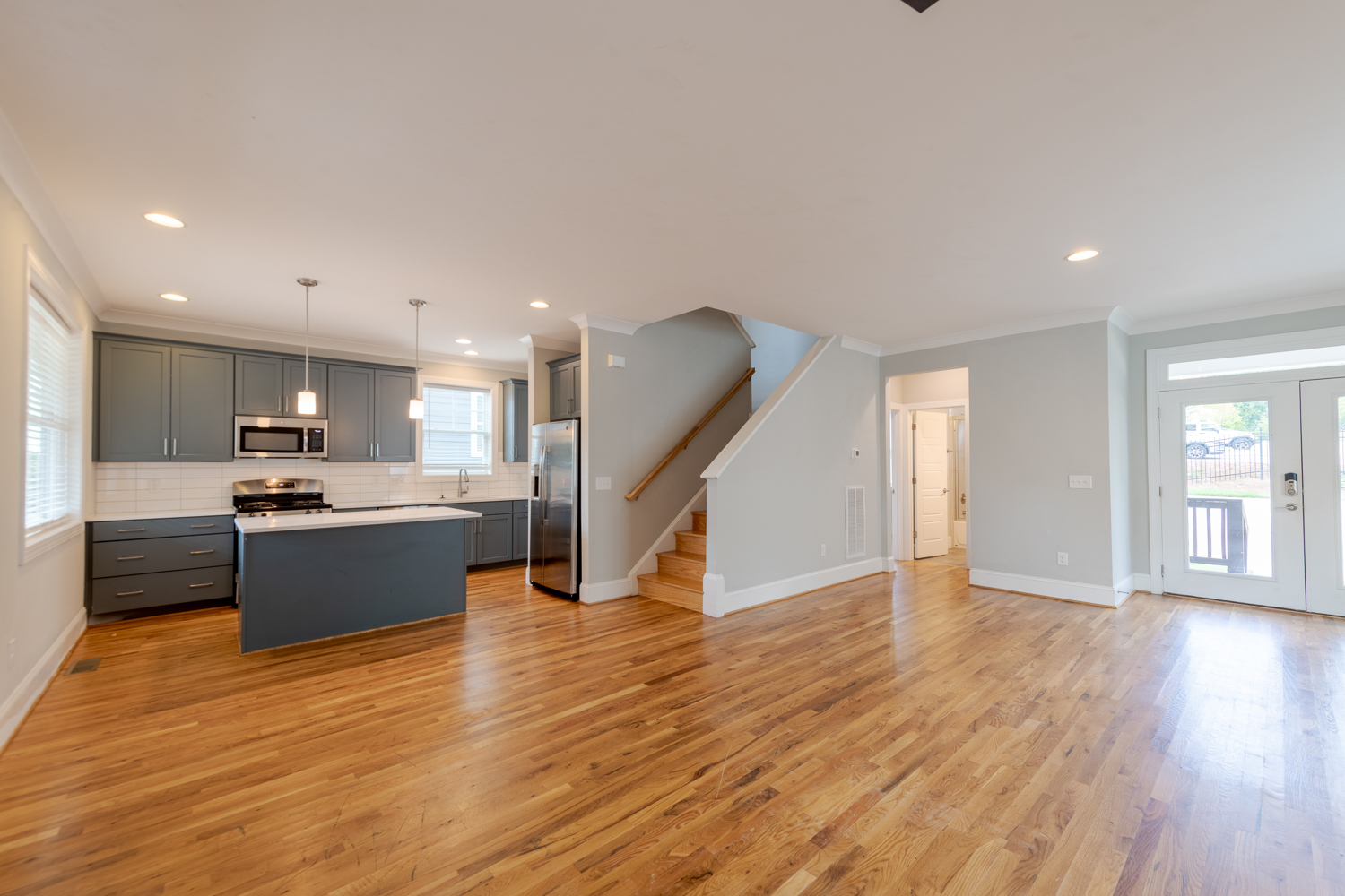 gorman row apartments near nc state living room kitchen hardwood flooring throughout